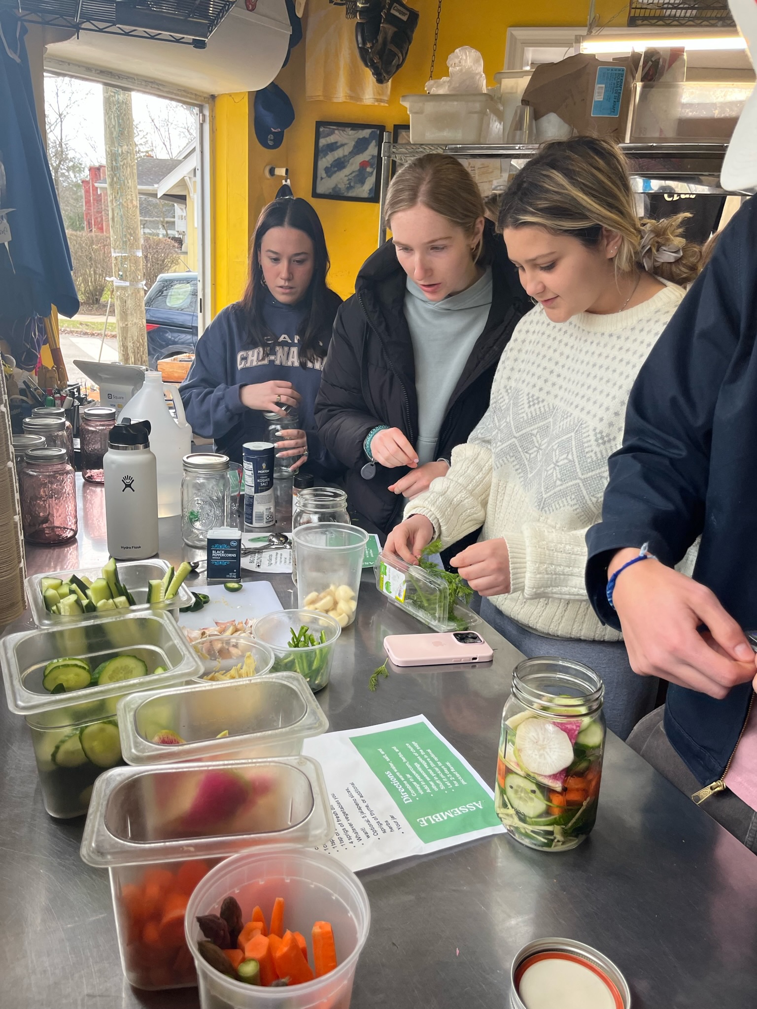 Three girls making pickles